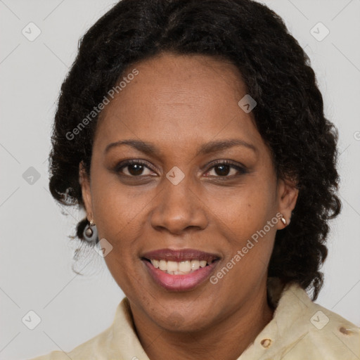 Joyful black adult female with medium  brown hair and brown eyes