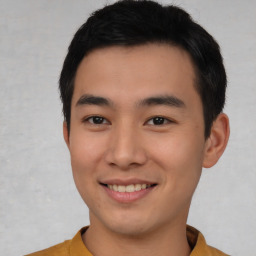 Joyful asian young-adult male with short  black hair and brown eyes