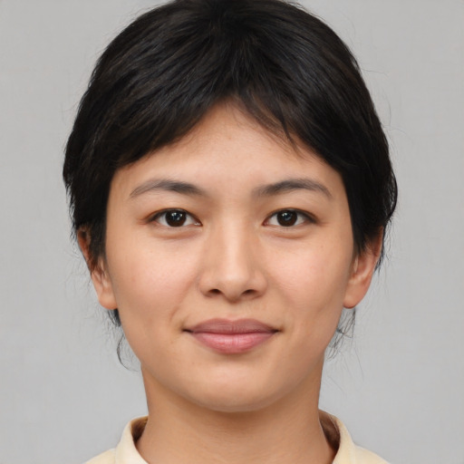 Joyful asian young-adult female with medium  brown hair and brown eyes
