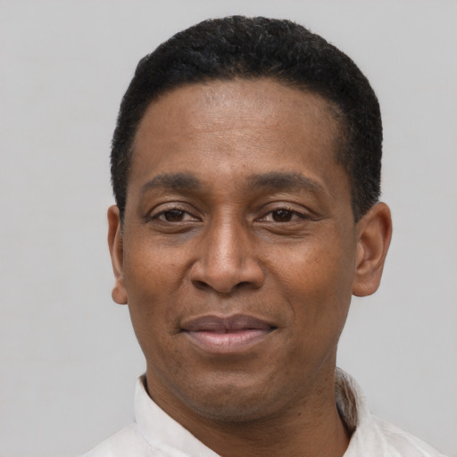 Joyful latino adult male with short  black hair and brown eyes