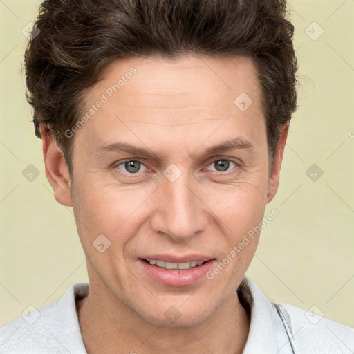 Joyful white adult male with short  brown hair and grey eyes