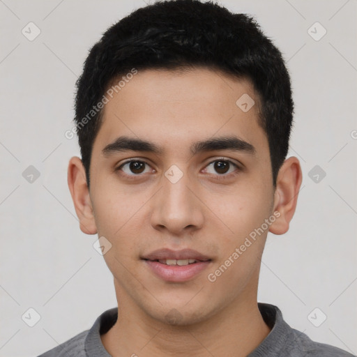 Joyful latino young-adult male with short  brown hair and brown eyes