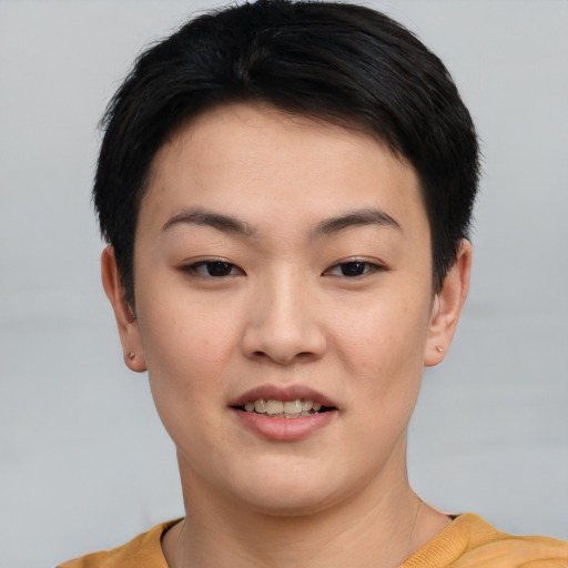 Joyful asian young-adult female with short  brown hair and brown eyes