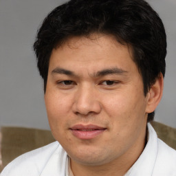 Joyful asian adult male with short  brown hair and brown eyes