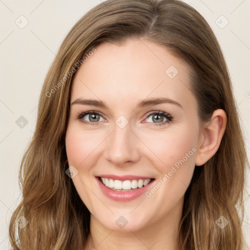 Joyful white young-adult female with long  brown hair and green eyes