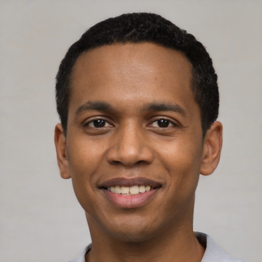 Joyful black young-adult male with short  black hair and brown eyes