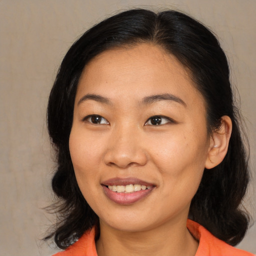 Joyful asian young-adult female with medium  brown hair and brown eyes