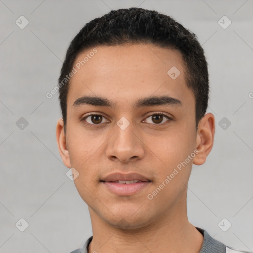 Joyful latino young-adult male with short  black hair and brown eyes