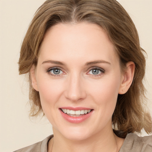 Joyful white young-adult female with medium  brown hair and green eyes