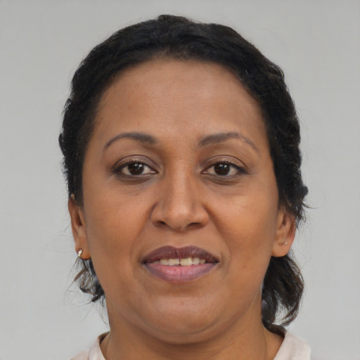 Joyful black adult female with medium  brown hair and brown eyes