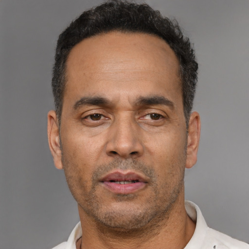 Neutral latino adult male with short  black hair and brown eyes