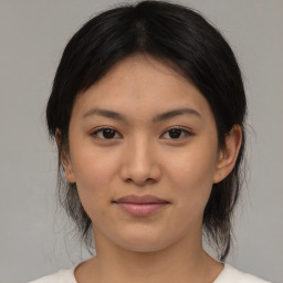 Joyful asian young-adult female with medium  brown hair and brown eyes