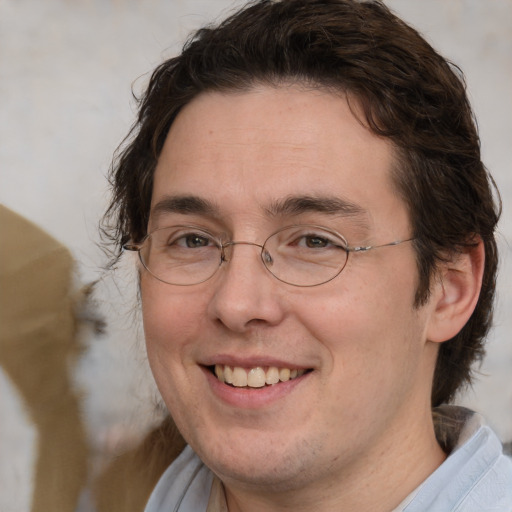 Joyful white adult male with medium  brown hair and brown eyes