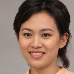 Joyful asian young-adult female with medium  brown hair and brown eyes