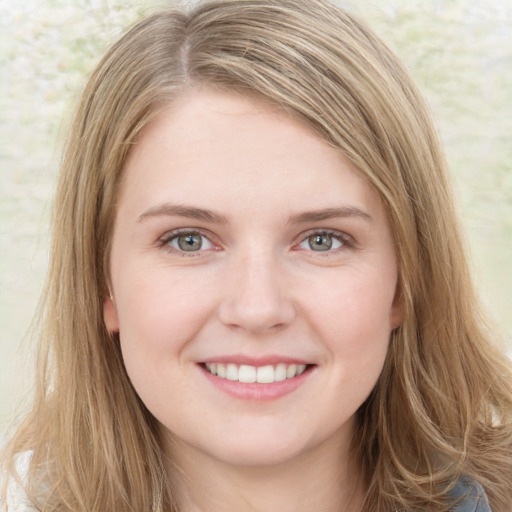 Joyful white young-adult female with long  brown hair and green eyes