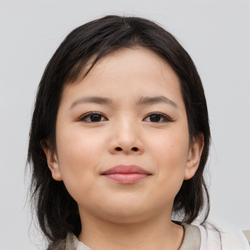 Joyful asian child female with medium  brown hair and brown eyes