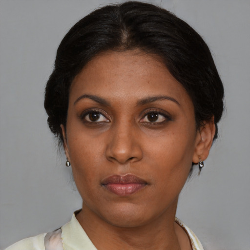 Neutral black young-adult female with medium  brown hair and brown eyes
