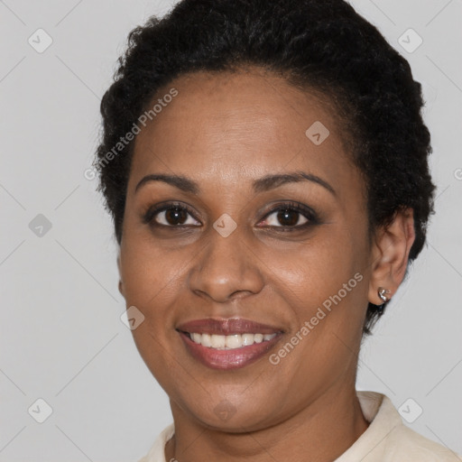 Joyful black adult female with short  brown hair and brown eyes