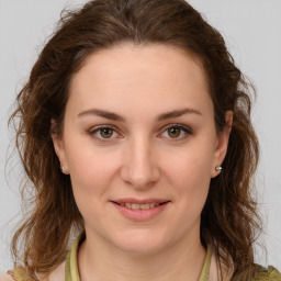 Joyful white young-adult female with medium  brown hair and green eyes