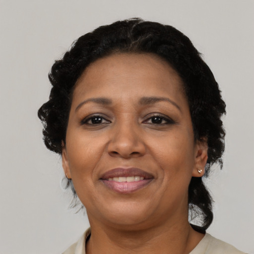 Joyful black adult female with short  black hair and brown eyes