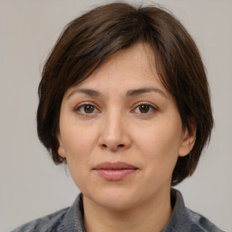 Joyful white adult female with medium  brown hair and brown eyes