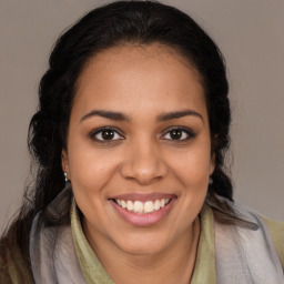 Joyful latino young-adult female with long  brown hair and brown eyes