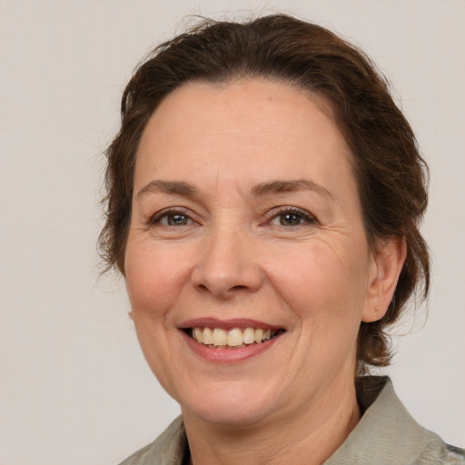 Joyful white adult female with medium  brown hair and brown eyes