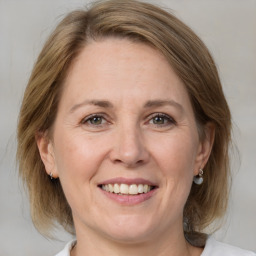 Joyful white adult female with medium  brown hair and brown eyes