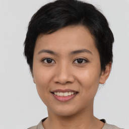 Joyful asian young-adult female with short  black hair and brown eyes