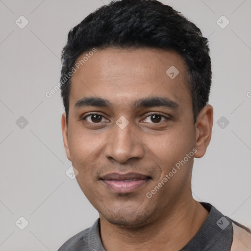 Joyful latino young-adult male with short  black hair and brown eyes