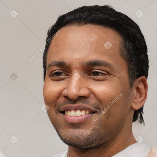 Joyful white adult male with short  black hair and brown eyes