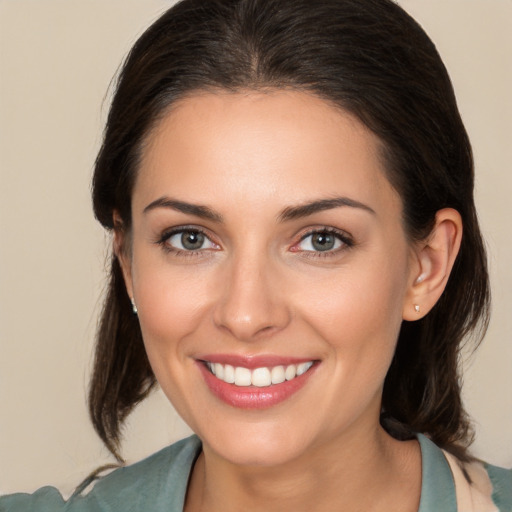 Joyful white young-adult female with medium  brown hair and brown eyes