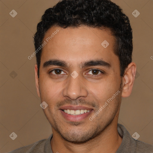 Joyful latino young-adult male with short  brown hair and brown eyes