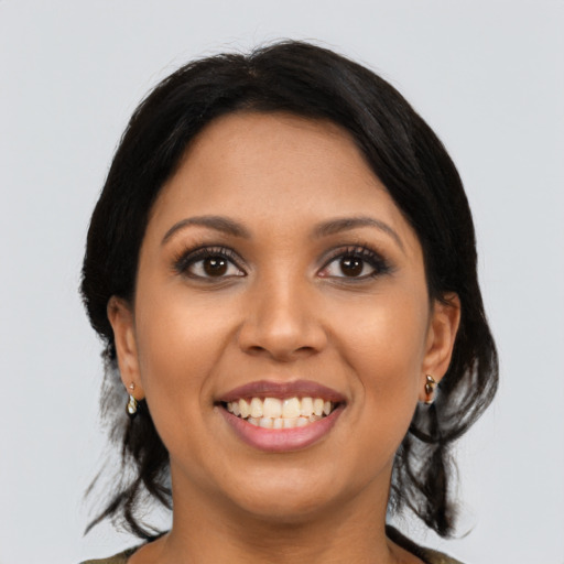 Joyful latino young-adult female with medium  black hair and brown eyes
