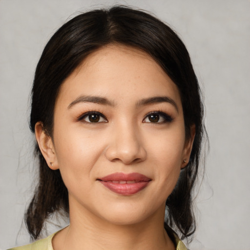 Joyful white young-adult female with medium  black hair and brown eyes