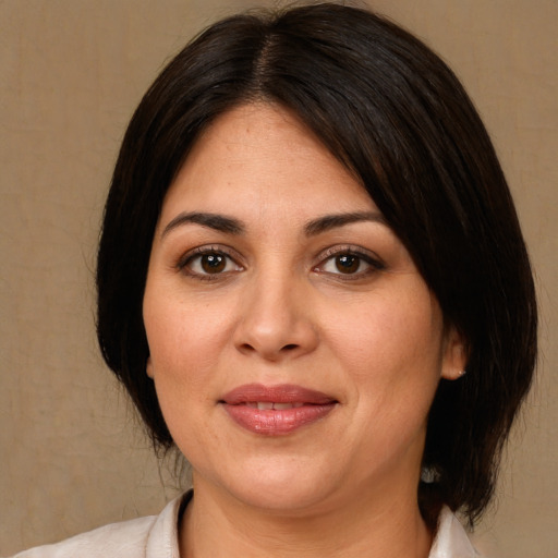 Joyful white young-adult female with medium  brown hair and brown eyes