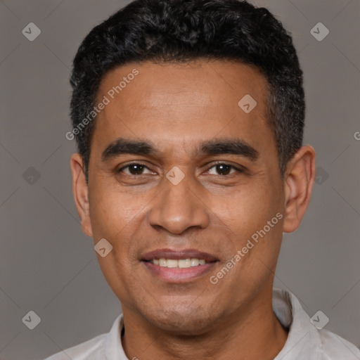 Joyful latino adult male with short  black hair and brown eyes