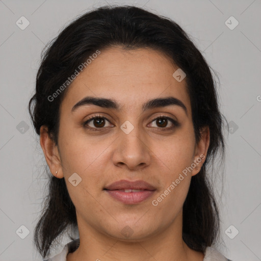 Joyful latino young-adult female with medium  brown hair and brown eyes