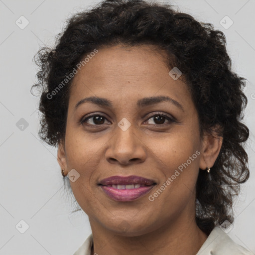 Joyful black adult female with medium  brown hair and brown eyes