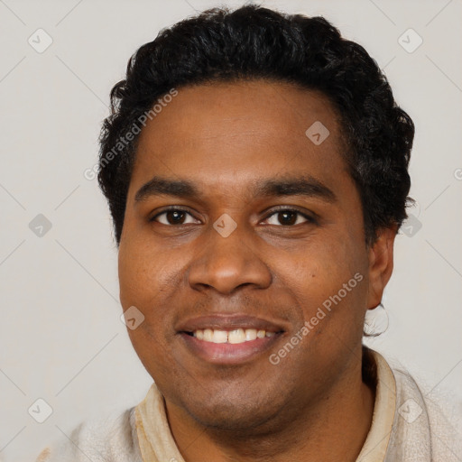 Joyful black young-adult male with short  black hair and brown eyes