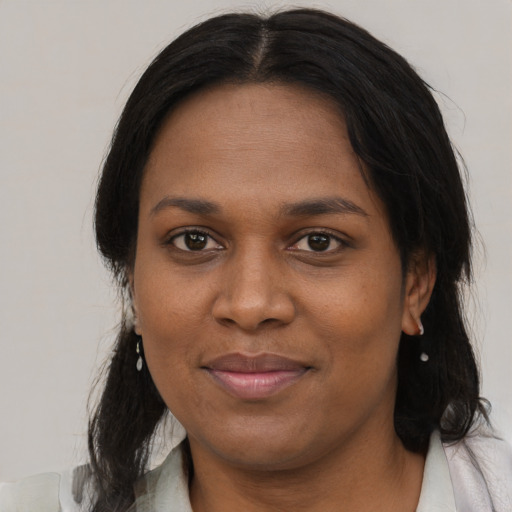 Joyful black young-adult female with medium  brown hair and brown eyes