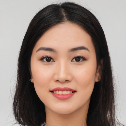 Joyful asian young-adult female with long  brown hair and brown eyes