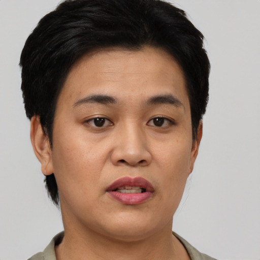 Joyful asian young-adult female with short  black hair and brown eyes