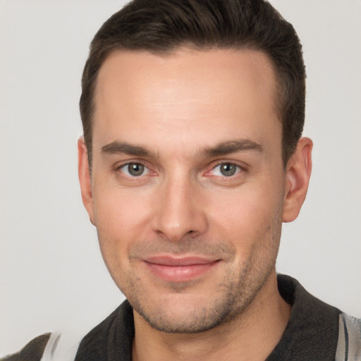 Joyful white young-adult male with short  brown hair and brown eyes