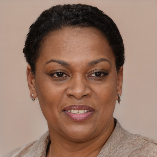 Joyful black adult female with short  brown hair and brown eyes