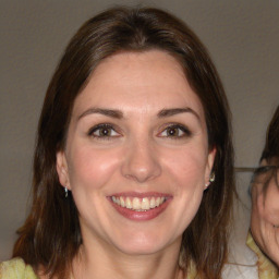 Joyful white young-adult female with medium  brown hair and brown eyes