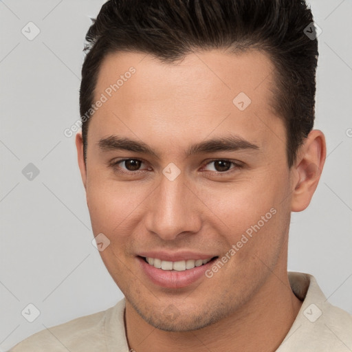 Joyful white young-adult male with short  brown hair and brown eyes