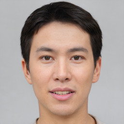 Joyful asian young-adult male with short  black hair and brown eyes