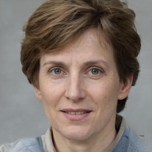 Joyful white adult female with short  brown hair and grey eyes