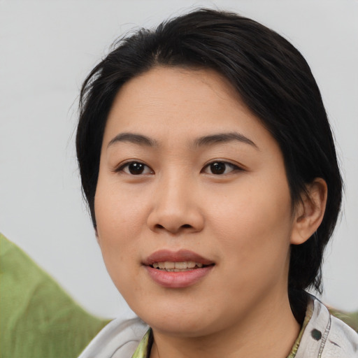 Joyful asian young-adult female with medium  black hair and brown eyes